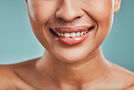 Closeup view of a mixed race woman posing against a green background. Female showing her healthy smooth soft skin in a studio