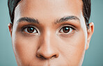 Closeup view of a mixed race woman posing against a green background. Female showing her healthy smooth soft skin in a studio