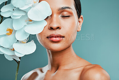 Buy stock photo Flower, skincare and woman in studio, calm and treatment for skin, spa and moisture and antioxidant. Green background, hydration and wellness with dermatology, antiaging and plant for glow and beauty