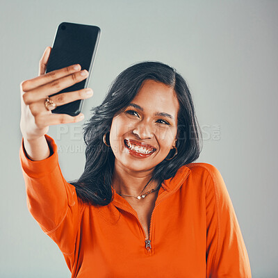 Buy stock photo Influencer, gen z or happy woman with selfie in studio for vlogging, social media or fashion by gray background. Smile, model and girl taking picture for photography and post online for trendy style