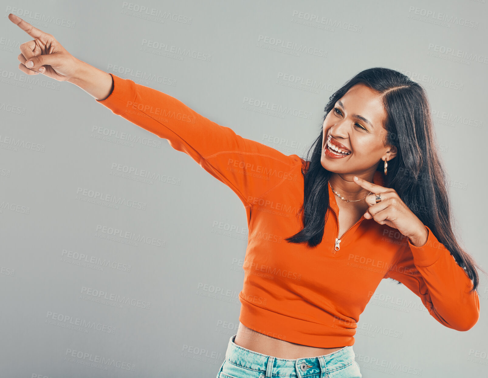 Buy stock photo Happy, woman and pointing for direction in studio with announcement, competition giveaway and retail sale. Smile, girl and show sign for advertising, coming soon and promotion vote on gray background