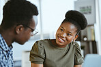 Two african american businesspeople having a meeting together at work. Businessman and businesswoman talking in an office. Man and woman working on a business plan