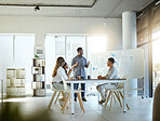 Group of diverse businesspeople having a meeting in an office at work. Young african american businessman talking while doing a presentation at a table for coworkers