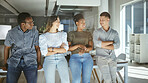 Group of happy businesspeople standing and talking together in an office. Content business professionals standing with their arms crossed at work