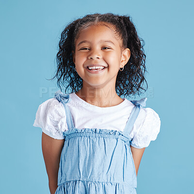 Buy stock photo Smile, youth and portrait of girl in studio for kindergarten, education and child development. Future, happiness and growth with face of kid on blue background for scholarship, knowledge and excited