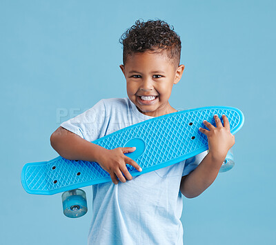 Buy stock photo Happy, toy and portrait of kid with skateboard in studio for birthday gift or surprise for childhood. Smile, present and boy from Mexico with plastic glissade for development by blue background.