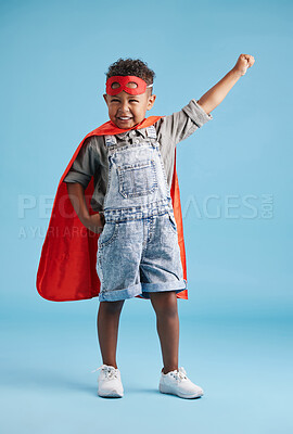 Buy stock photo Boy, child and superhero with mask in studio for flight, fantasy and playful for portrait by blue background. Kid, cape and excited with action, character and games with power for halloween party