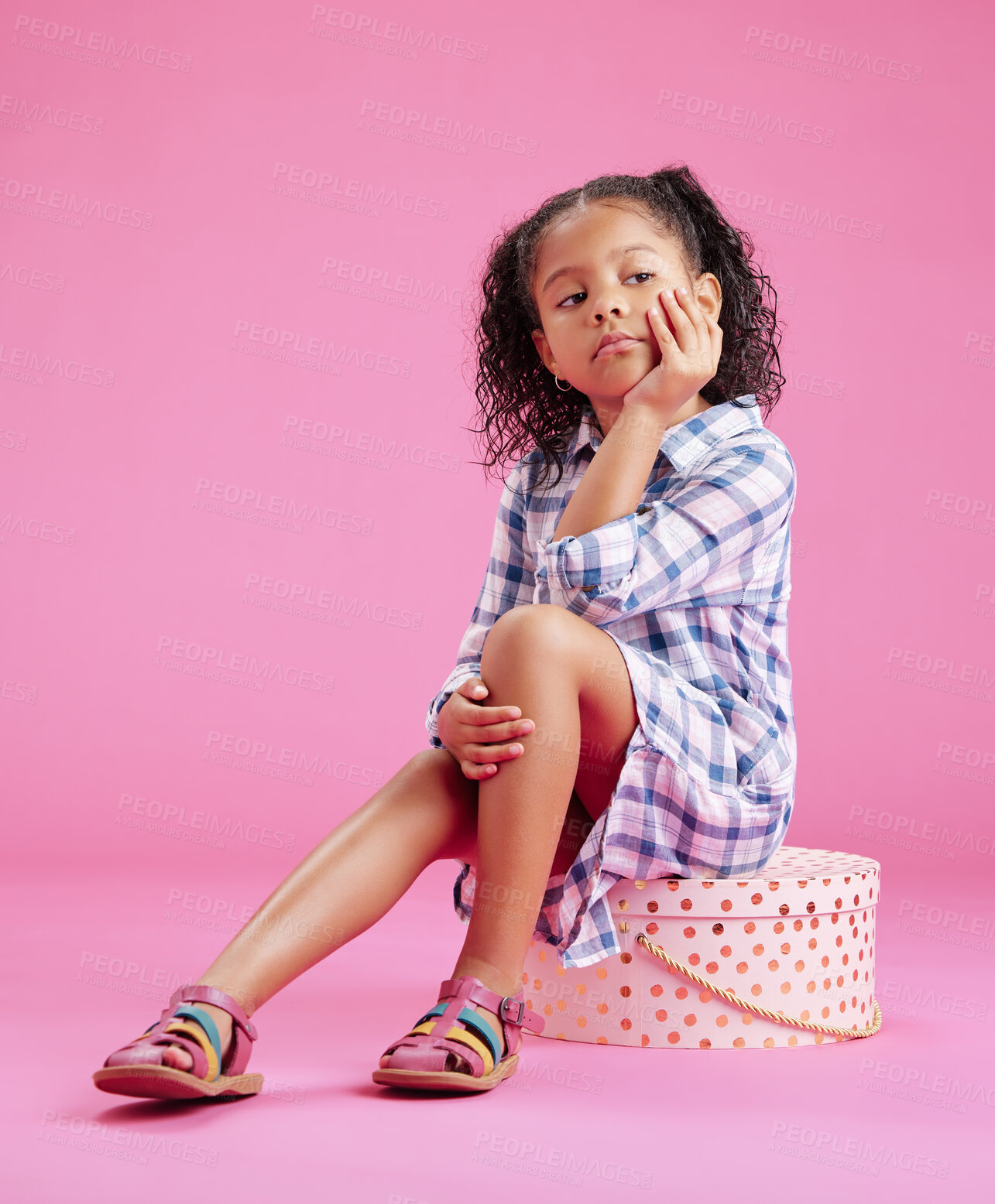 Buy stock photo Studio, gift and bored girl child with sad birthday present fashion, fatigue and unhappy mockup space. Frustrated, party style and annoyed kid sitting on box with grief, thinking and pink background