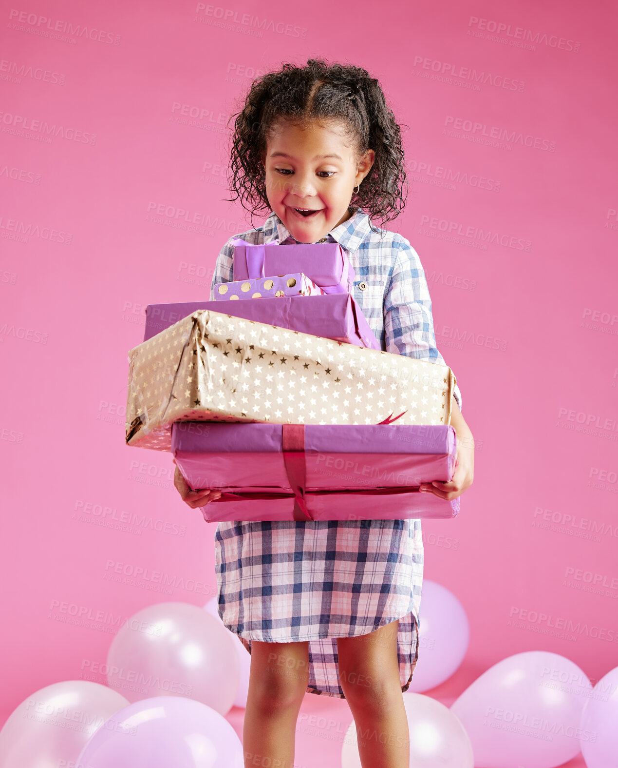 Buy stock photo Girl, child and boxes for birthday party in studio with wow, surprise or excited for gift by pink background. Kid, package and celebration with balloon, present or thinking for milestone in childhood