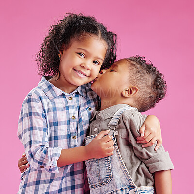 Buy stock photo Happy, kiss cheek and portrait of kids on pink background for bonding, love and cute relationship. Family, young children and brother and sister embrace for affection, care or fun together in studio