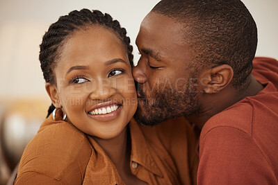 Buy stock photo Love, smile and black couple in home with kiss, trust and support in happy relationship together. Man, woman and relax in romantic embrace with partner bonding, marriage and weekend date in apartment