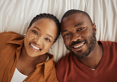 Buy stock photo Love, smile and portrait of black couple on bed with trust, confidence and happy in relationship together. Man, woman and above in bedroom for romantic morning bonding, marriage and weekend in home