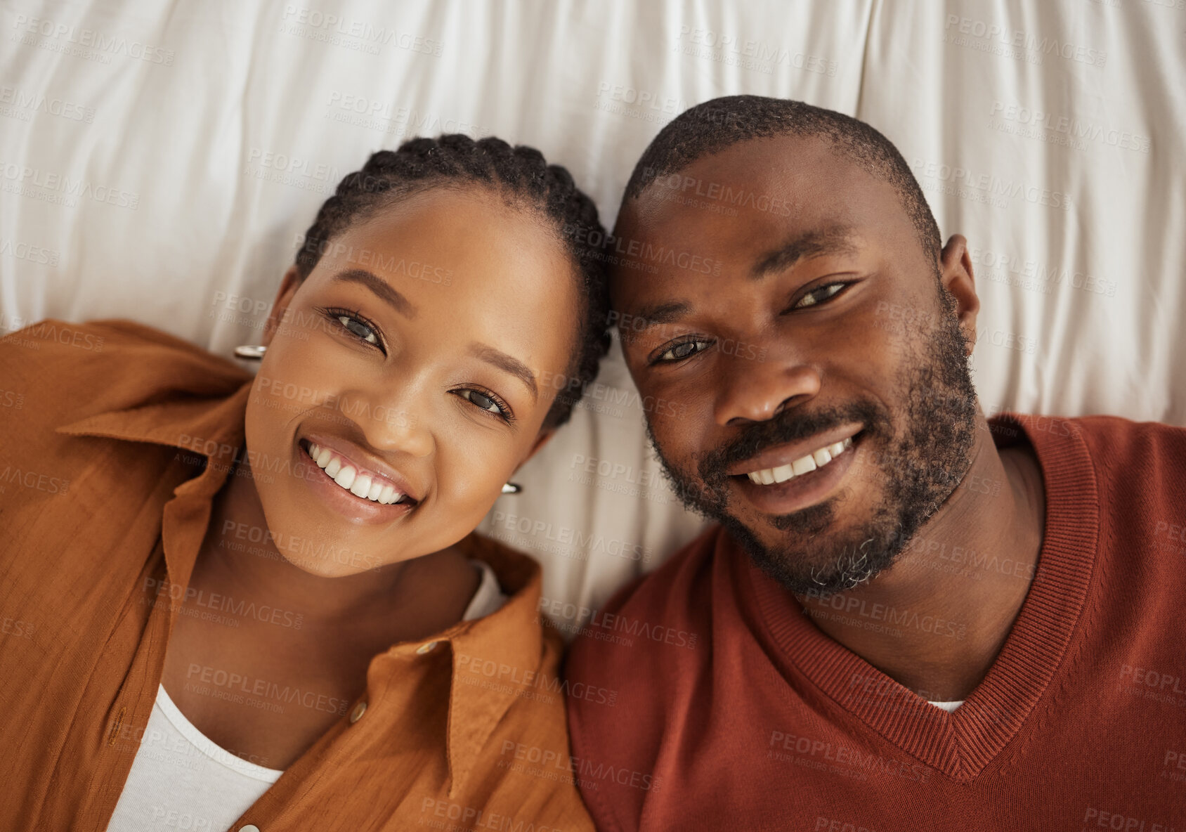 Buy stock photo Love, smile and portrait of black couple on bed with trust, confidence and happy in relationship together. Man, woman and above in bedroom for romantic morning bonding, marriage and weekend in home