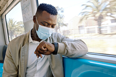 Buy stock photo Black man, train and check time on travel, journey and face mask for safety, virus or pollution. Person, clock and watch on business trip with ppe, reminder and public transport with thinking on ride