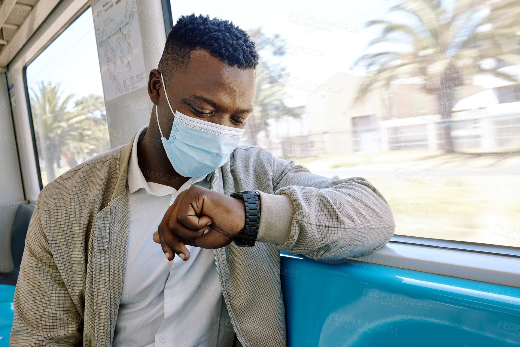 Buy stock photo Black man, train and check time on travel, journey and face mask for safety, virus or pollution. Person, clock and watch on business trip with ppe, reminder and public transport with thinking on ride