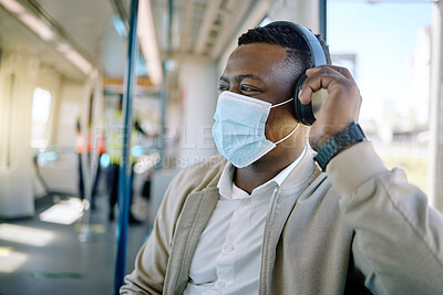 Buy stock photo Black man, headphone and face mask for train travel with compliance, health safety and morning transport. Male person, relax and listen to music for healthcare policy, city commute and ppe protection