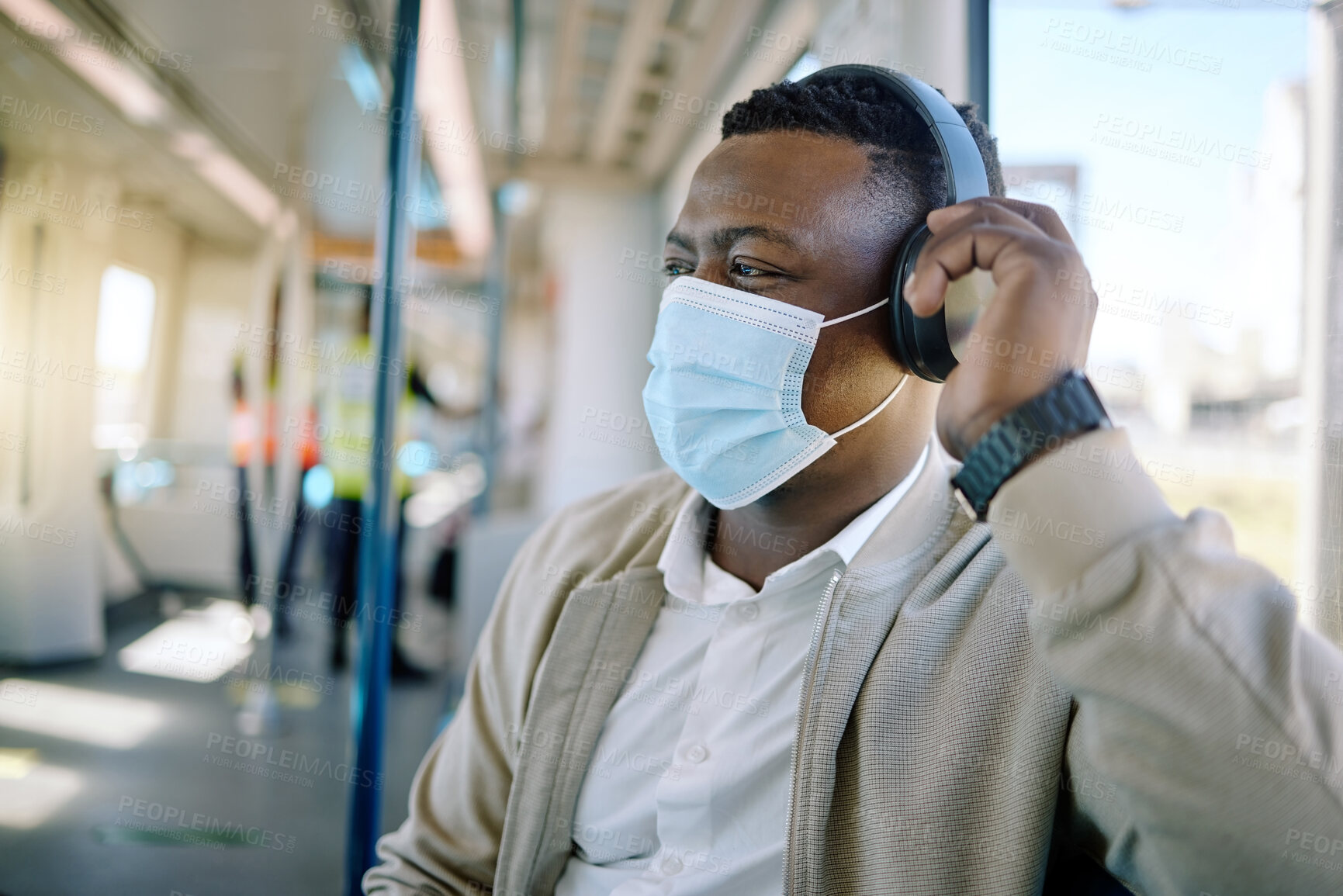 Buy stock photo Black man, headphone and face mask for train travel with compliance, health safety and morning transport. Male person, relax and listen to music for healthcare policy, city commute and ppe protection