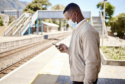 Buy stock photo Black man, phone and face mask for train travel with ppe compliance, metro safety and transport protocol. Delay, person and mobile app with schedule of covid19 control, commute protection and health
