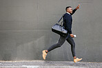 African american businessman travelling alone and rushing for a taxi  in the city. Black male running and waving for a taxi while on his way to work in the morning