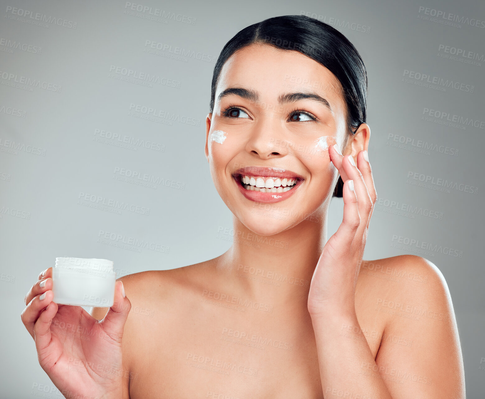 Buy stock photo Face cream, beauty and woman with skincare in studio with nourishment, hydration and glow. Happy, health and person with moisturizer for facial, cosmetic or dermatology routine by gray background.