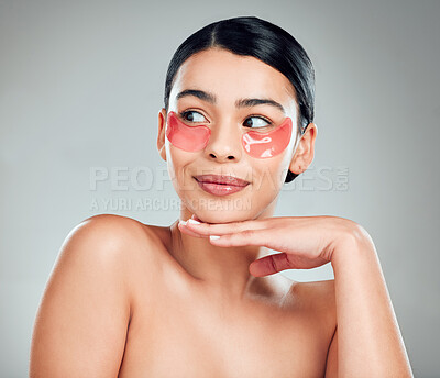 Buy stock photo Face, skincare and woman with patches for beauty, wellness  or facial treatment for hydration. Touch, cosmetics and model with eye mask for dermatology, glow and thinking on gray studio background