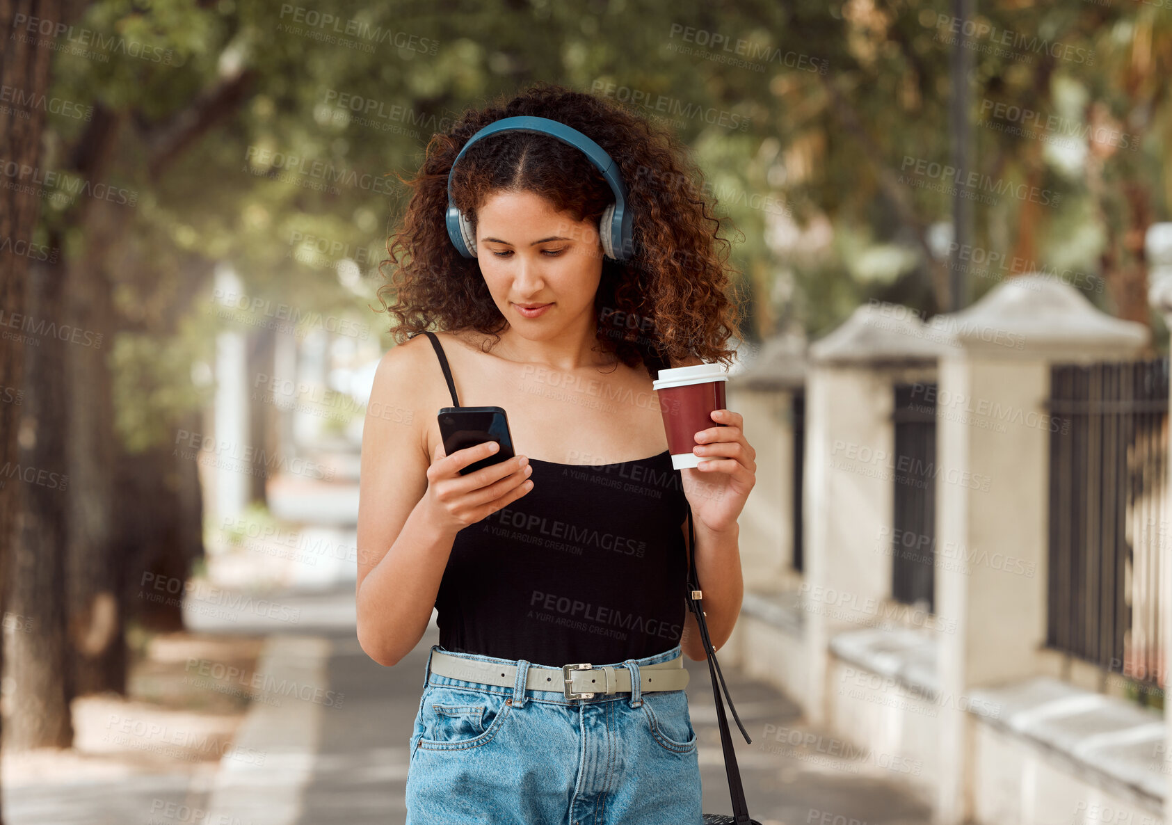 Buy stock photo Phone, headphones and woman in city with coffee, search and online podcast on outdoor walk. Travel, music streaming and gen z girl with drink, mobile app scroll or urban connection on morning commute