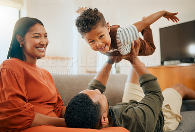 Buy stock photo Funny, airplane and energy with family on sofa for love, playful game and happiness together. Care, bonding and laughing with parents and child in living room at home for silly, comedy and support