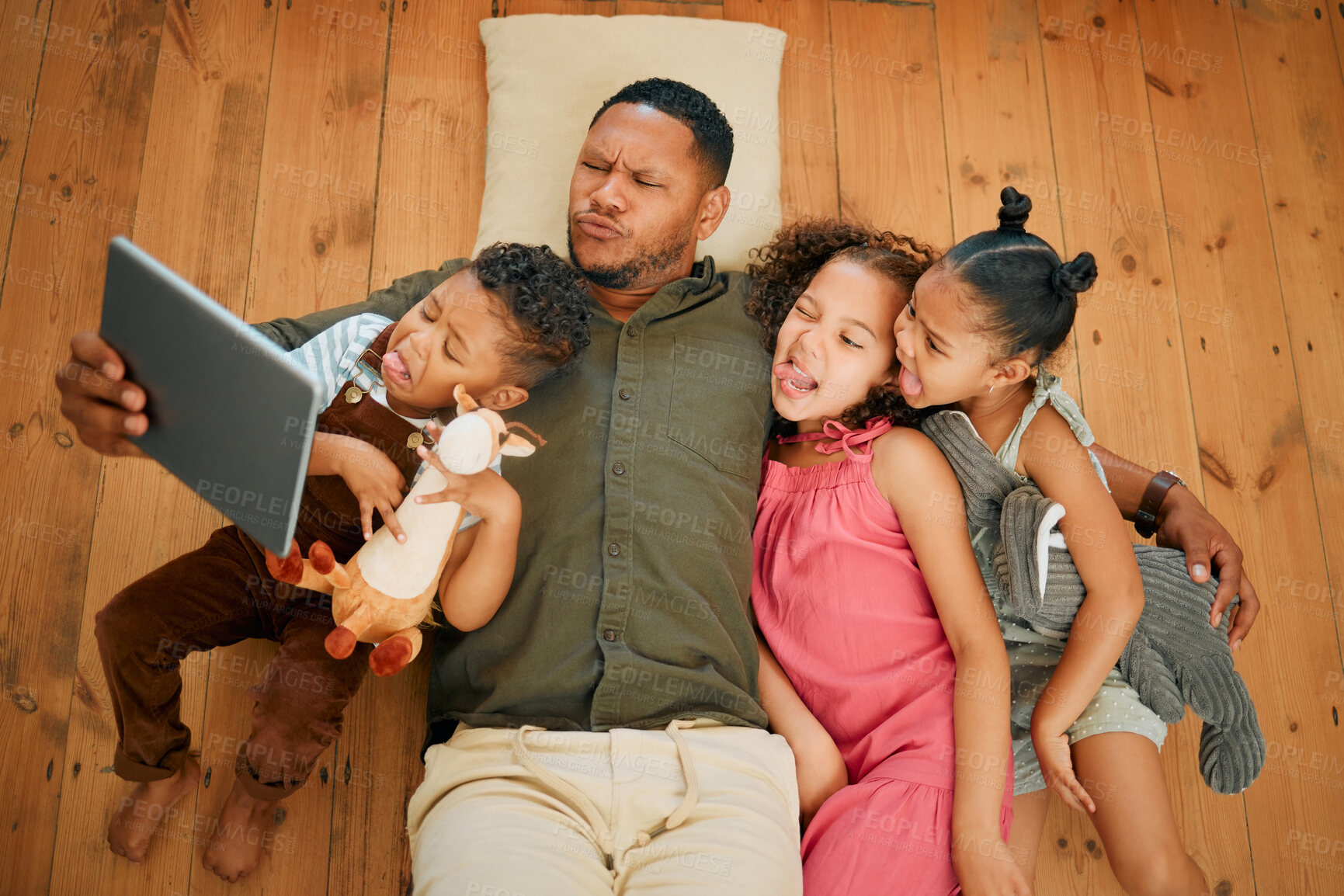 Buy stock photo Tablet, above and selfie with father and kids on floor for love, funny face and happiness. Care, photography and hug with man and children in living room of family home for support and social media