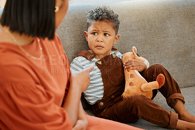 Buy stock photo Sofa, mother and discipline upset child in home for behavior problem, tantrum and punishment for attitude. Angry, woman and pointing at naughty boy kid on couch with warning, conflict or disappointed