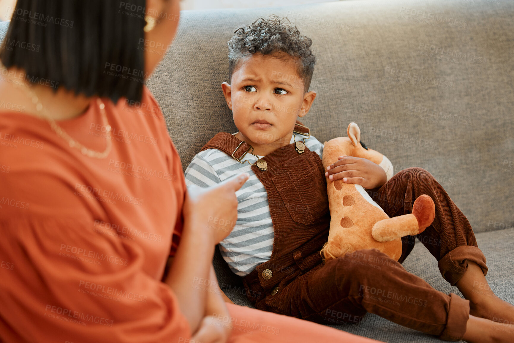 Buy stock photo Sofa, mother and discipline upset child in home for behavior problem, tantrum and punishment for attitude. Angry, woman and pointing at naughty boy kid on couch with warning, conflict or disappointed