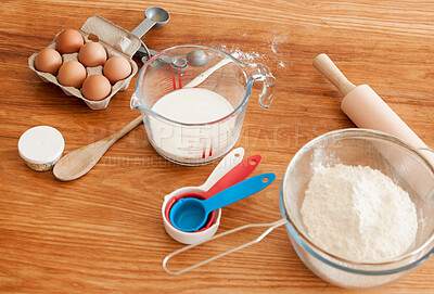 Buy stock photo Utensils, baking ingredients and eggs on kitchen counter with flour, container and spoon in home. Bowl, milk and rolling pin for process, cooking and prepare for dessert, cookie or cake at apartment