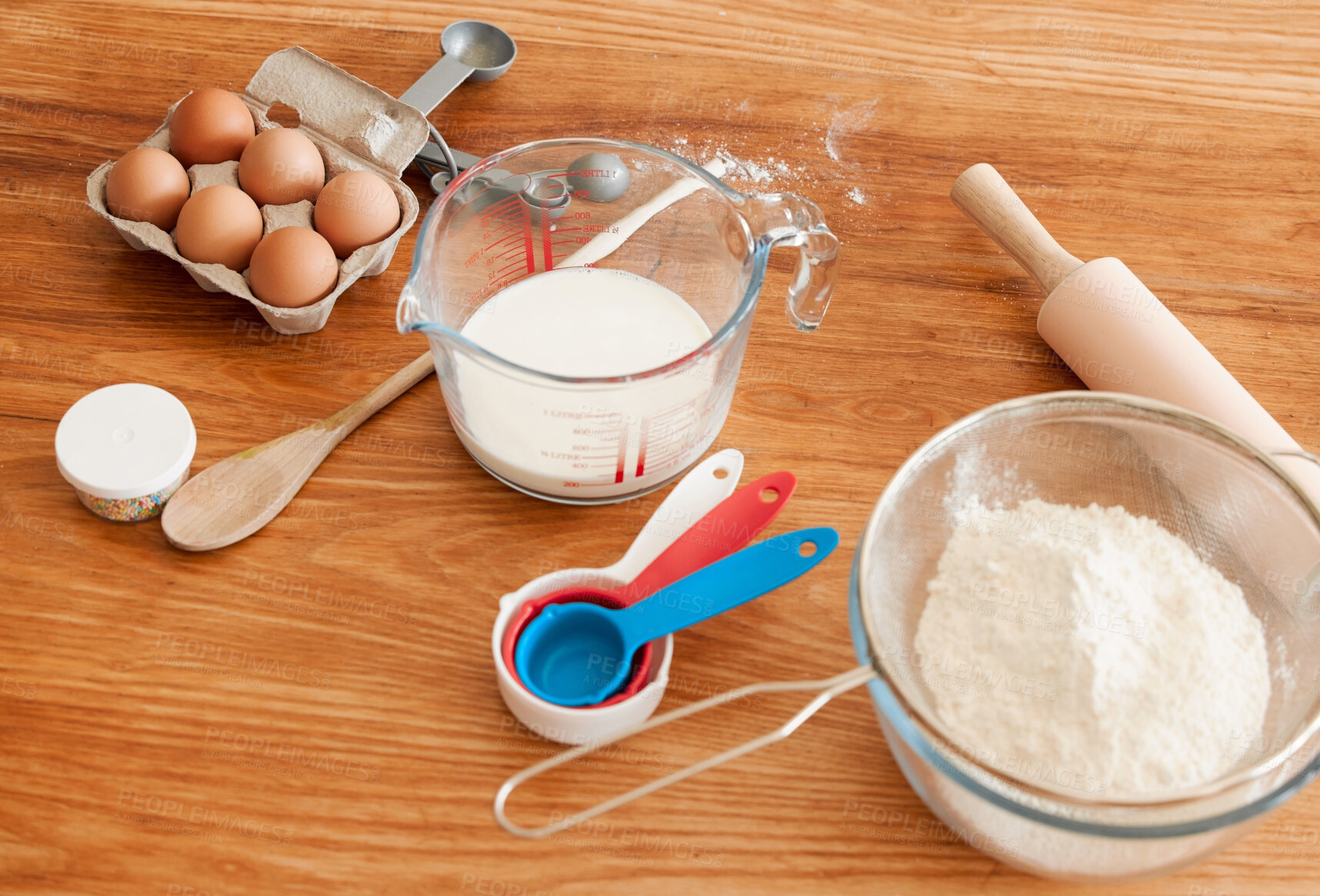 Buy stock photo Utensils, baking ingredients and eggs on kitchen counter with flour, container and spoon in home. Bowl, milk and rolling pin for process, cooking and prepare for dessert, cookie or cake at apartment