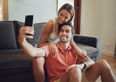 Buy stock photo Couple, selfie and media post in home, love and online photography for bonding together. Happy people, support and camera app for profile picture in living room, romance and relax on weekend date