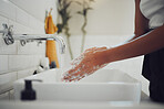 Close up of female hands using soap and washing hands with clean water under tap. Woman lathering and rinsing to prevent the spread of germs, bacterial infections