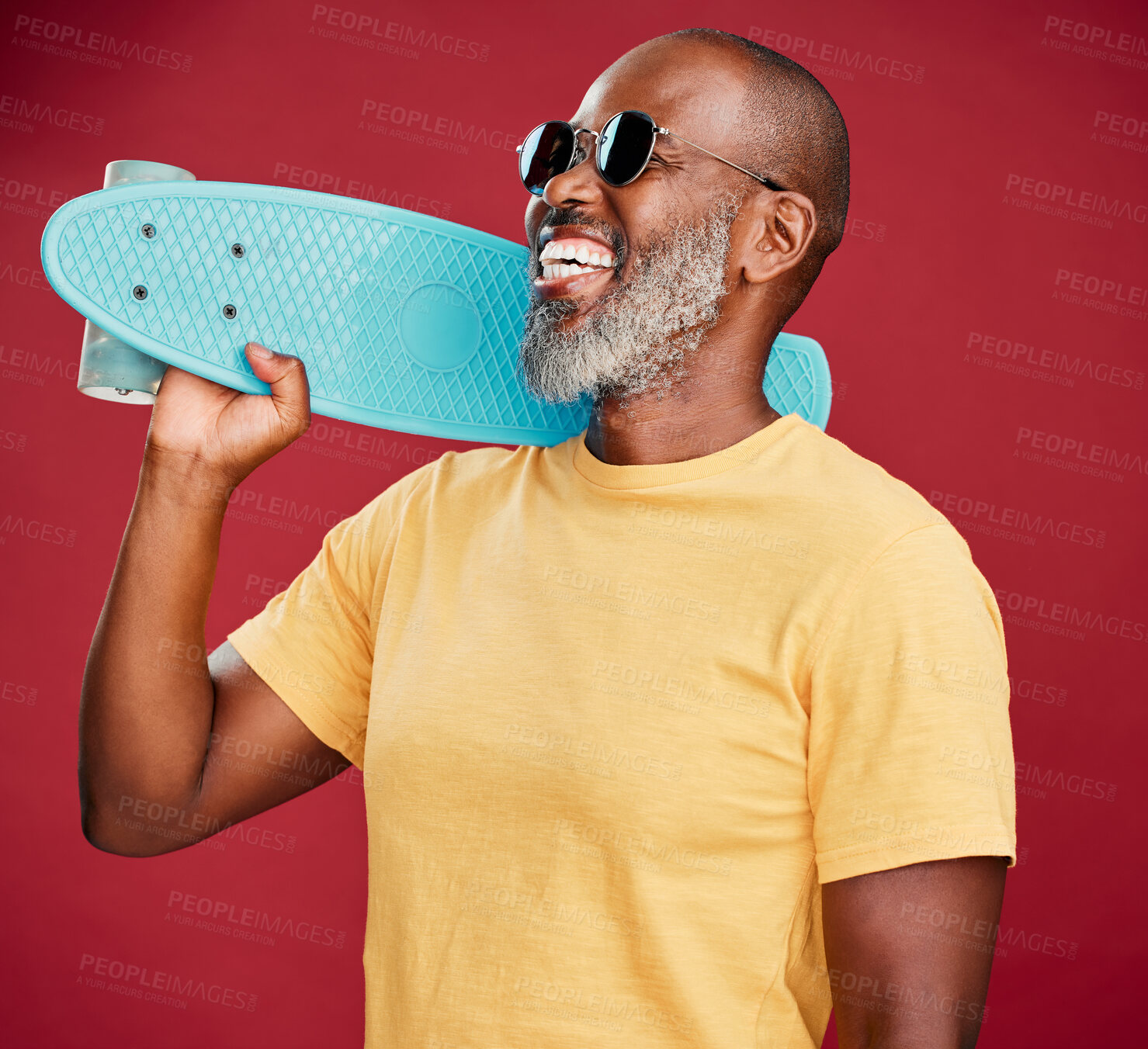 Buy stock photo Sunglasses, skateboard and fashion with black man in studio for cool, confidence and happiness. Trendy, excited and aesthetic with mature person on red background for hipster, creative and accessory