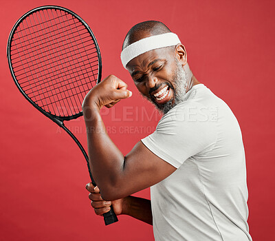 Buy stock photo Happy, celebration and man with racket, studio and flex of muscle for win in match, confident and player. Red background, success and fitness of black person, workout or health of athlete with tennis