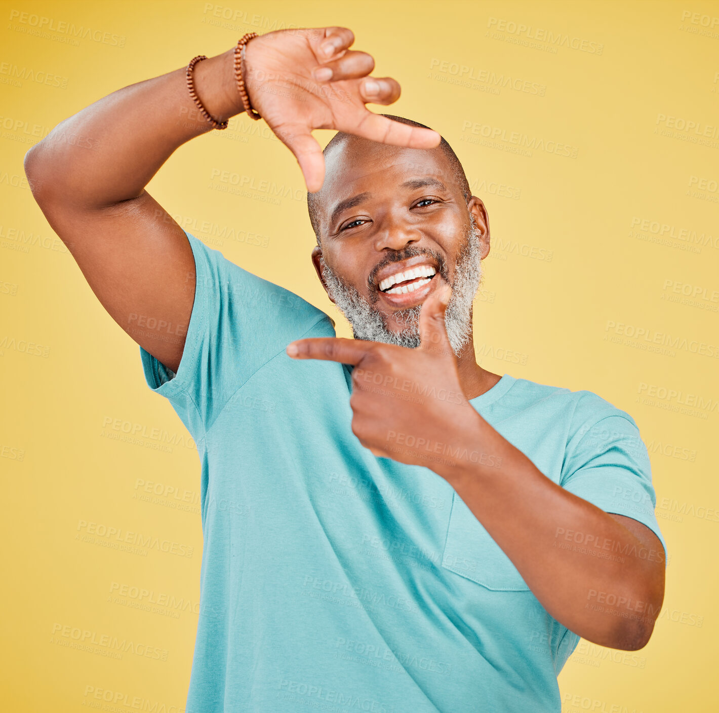 Buy stock photo Mature, portrait and black man with hand frame for picture, photography or selfie on a yellow studio background. African, male person or happy model with smile for capture moment, shape or memory