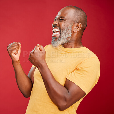 Buy stock photo Excited, fist pump and success with mature black man in studio isolated on red background for celebration. Deal, motivation and winner with happy senior person cheering for bonus, goals or target