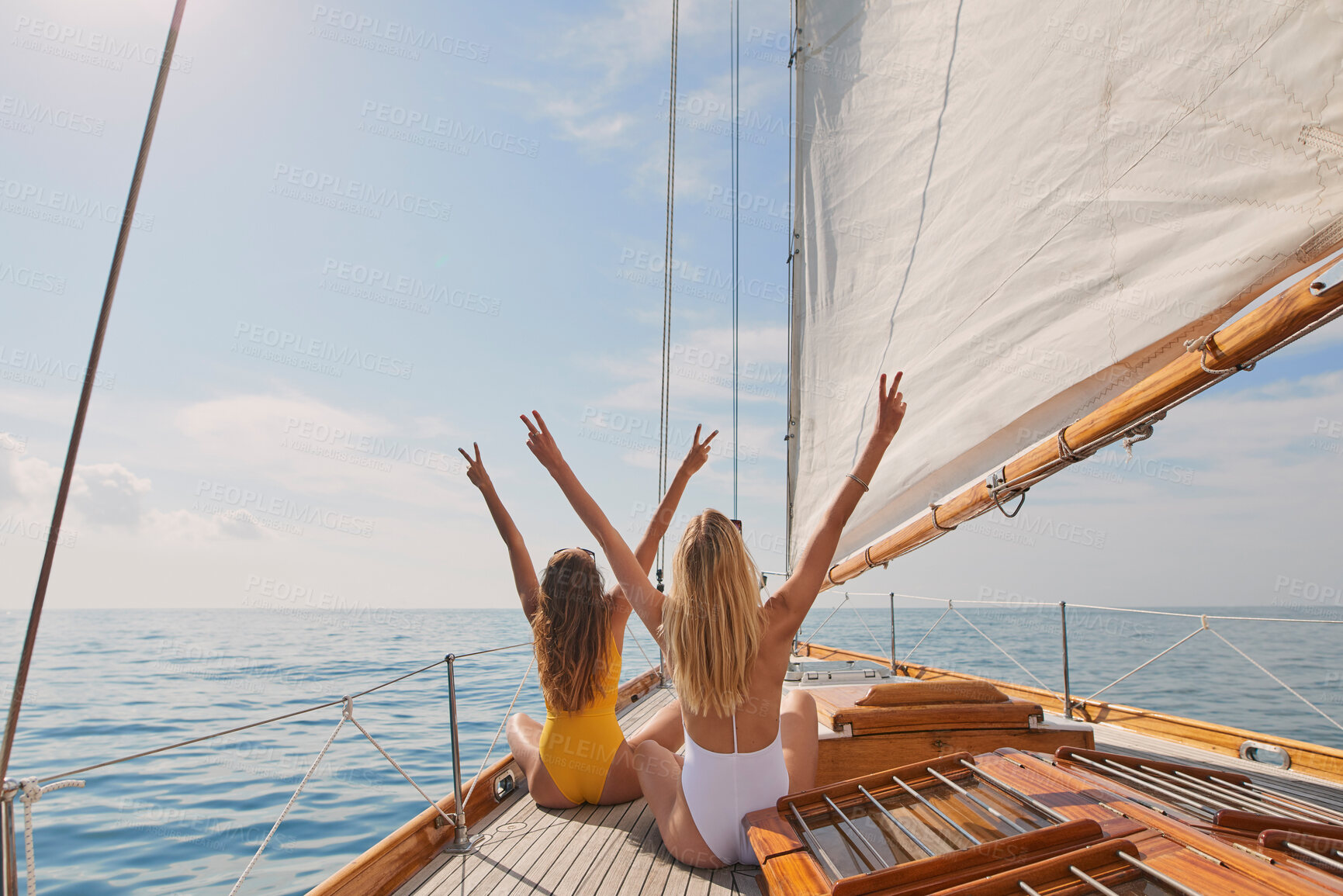 Buy stock photo Friends, women and holiday in bikini on yacht with peace sign, travel adventure and summer celebration. Back, freedom and arms raised in boat for vacation cruise, tropical island and bonding together