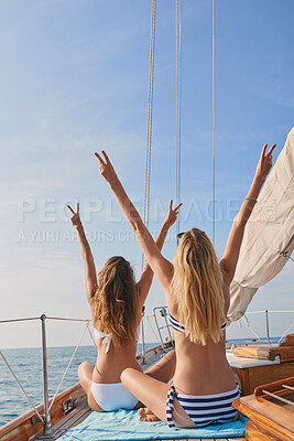 Buy stock photo Friends, women and travel for cruise on yacht with peace sign, freedom and holiday adventure in bikini. Back, mockup and arms raised in boat for summer vacation, tropical island and bonding together