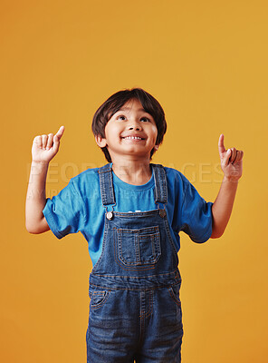 Buy stock photo Kid, pointing up and boy with announcement, showing and promotion on studio background. Model, opportunity and childhood with discount deal, notification and alert with option, direction or choice