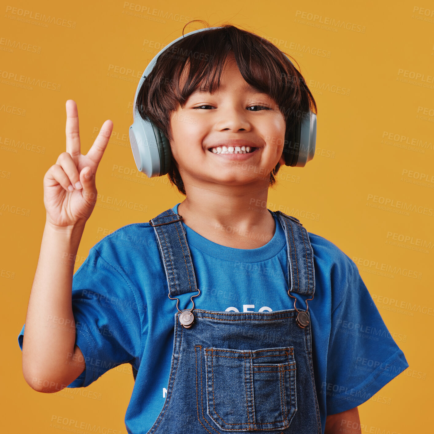 Buy stock photo Asian boy, portrait and headphones with sound, peace sign and happiness on yellow studio background. Review audio, radio or model with headset, support and smile with tech, child friendly and emoji