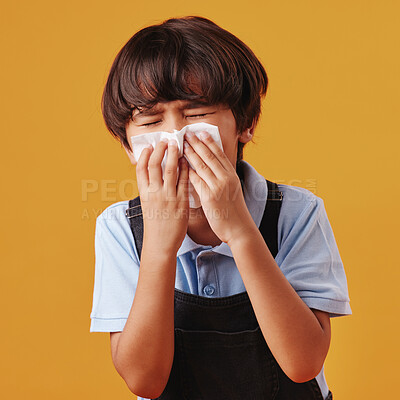 Buy stock photo Boy, blowing nose and sick child on studio background, allergies and cold or respiratory disease. Male person, tissue and flu for blocked nasal symptoms, hayfever and exhausted kid with bacteria