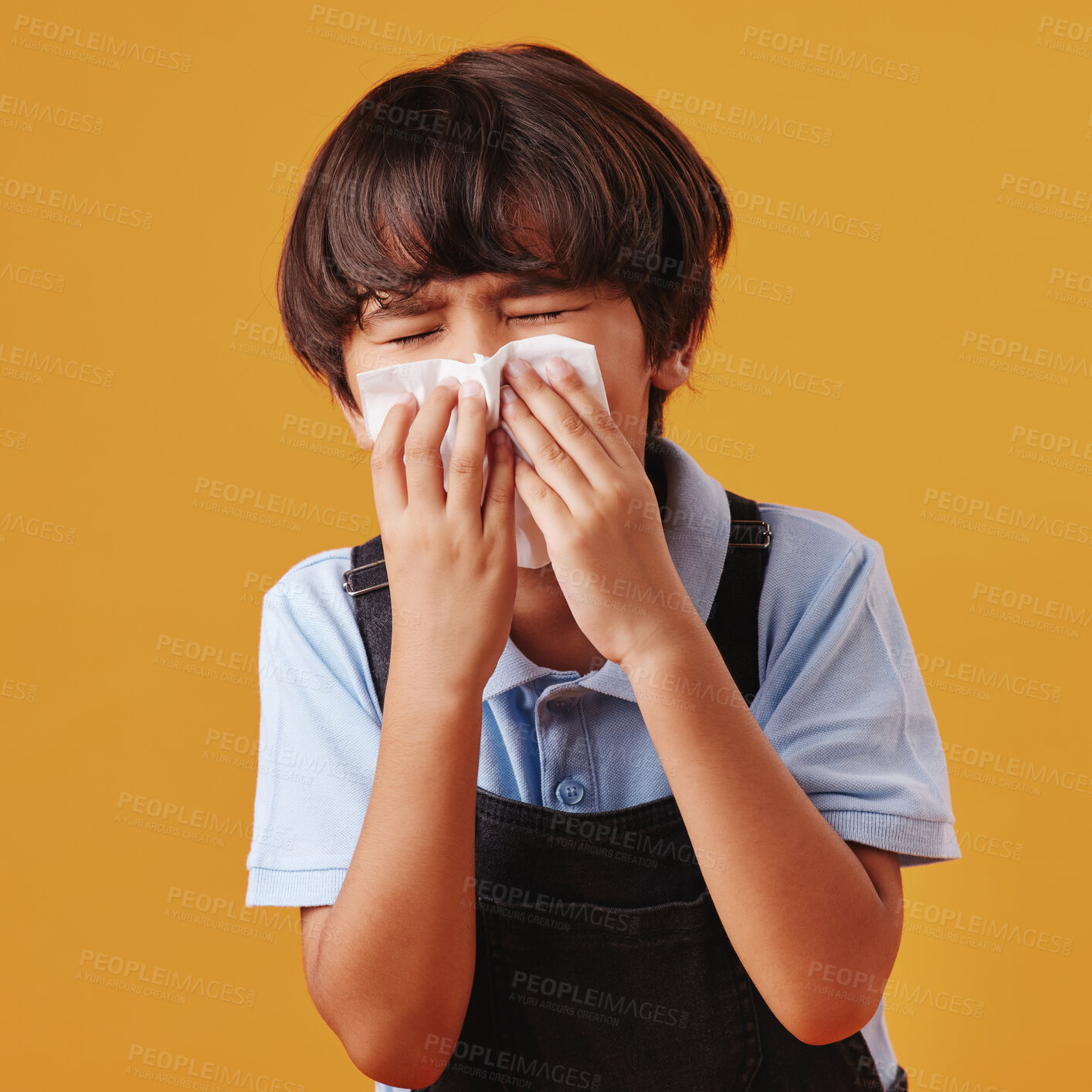 Buy stock photo Boy, blowing nose and sick child on studio background, allergies and cold or respiratory disease. Male person, tissue and flu for blocked nasal symptoms, hayfever and exhausted kid with bacteria