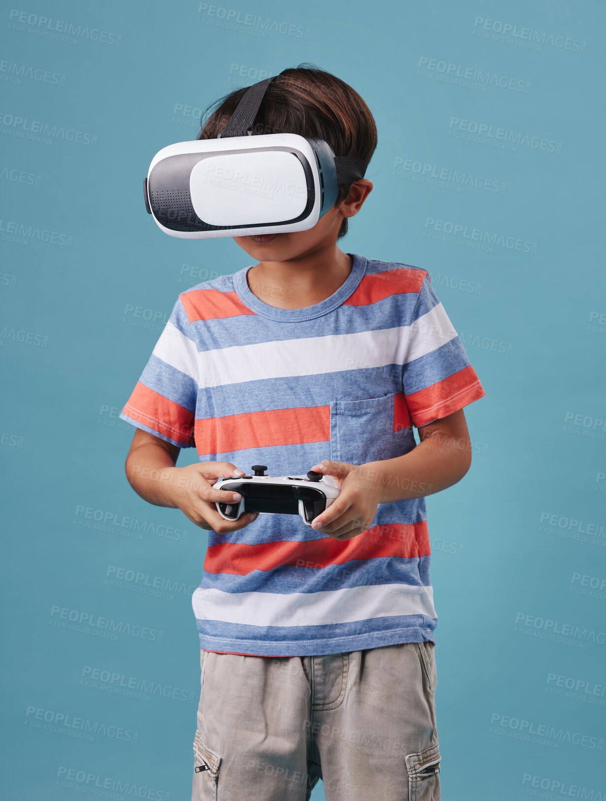 Buy stock photo Boy, vr headset and controller for games in studio, streaming online and cyber interaction. Male person, entertainment and goggles for virtual world, blue background and console for user experience