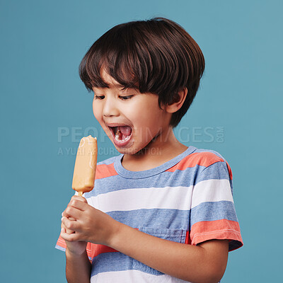 Buy stock photo Japanese boy, bite and popsicle in studio background with sweet snack or sucker for fun. Male person, kid and happy for eating with unhealthy food, dessert and treat with candy and ice cream