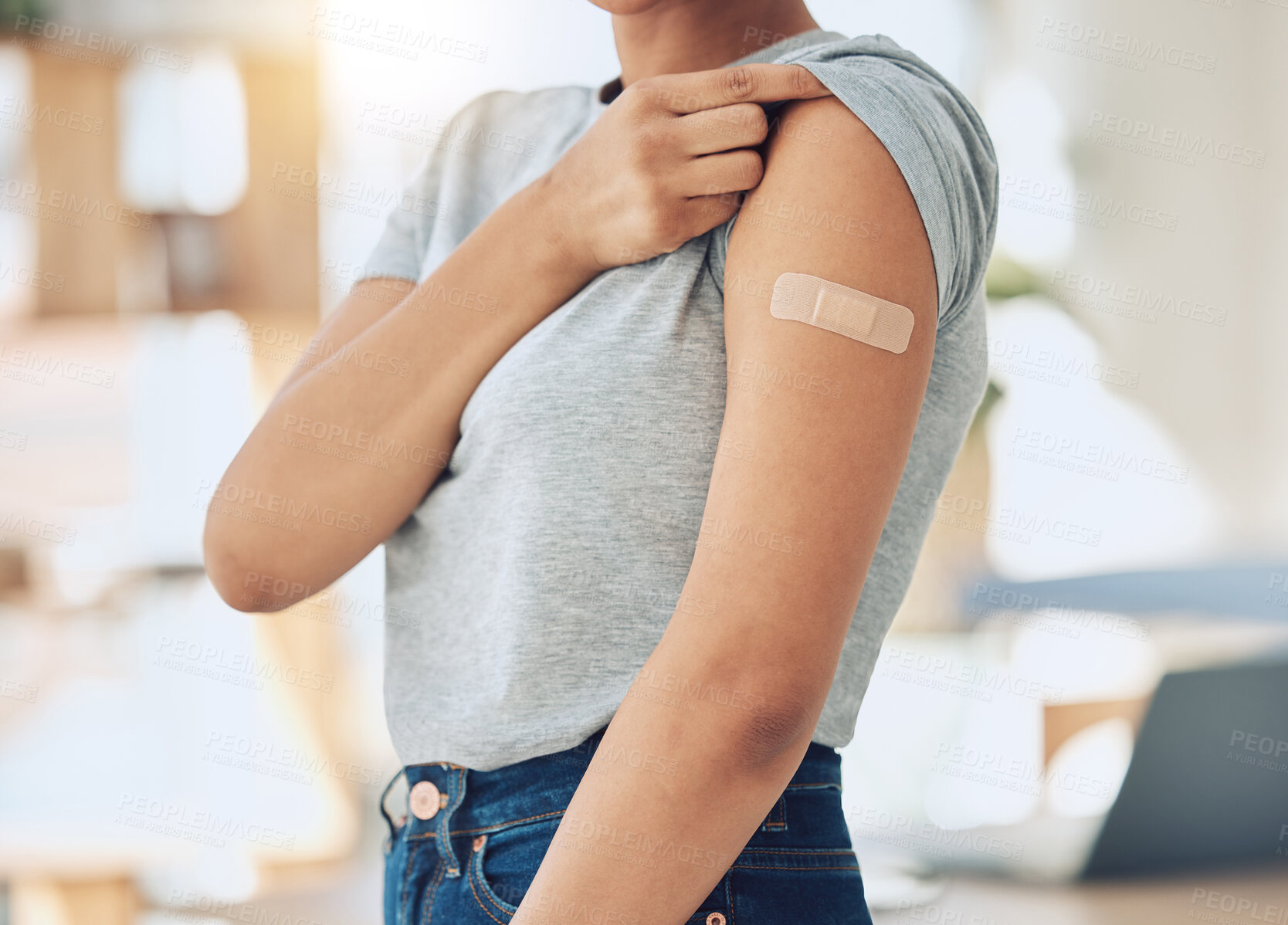 Buy stock photo Woman, arm and vaccine with plaster for healthcare, cure or immunity in recovery at home. Closeup of female person with covid vaccination, health protection or medical injection at house