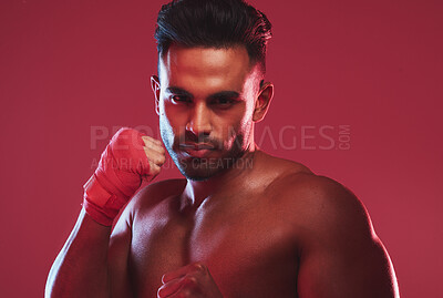 Buy stock photo Man, martial arts and fist in studio portrait with power, gloves and training for competition by red background. Person, fighter and shirtless for muay thai, kickboxing and combat sports in Colombia