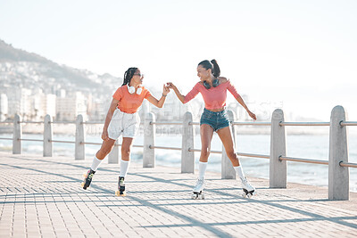 Buy stock photo Black women, fist bump and roller skating happy friends by the sea, ocean or shore outdoors. Support, partnership and girl team collaboration or fun while traveling down promenade together.

