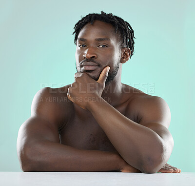 Buy stock photo Confident, handsome and portrait of a young black man isolated on a blue background in studio. Sexy, skincare and healthy body of an African model with muscle, confidence and seduction on a backdrop